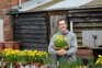 Monty holding a pot of tete-a-tete daffodils