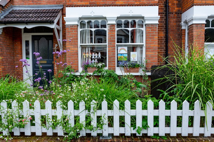 Picket fencing with colourful planting. Paul Debois Picket fencing with colourful planting. Paul Debois