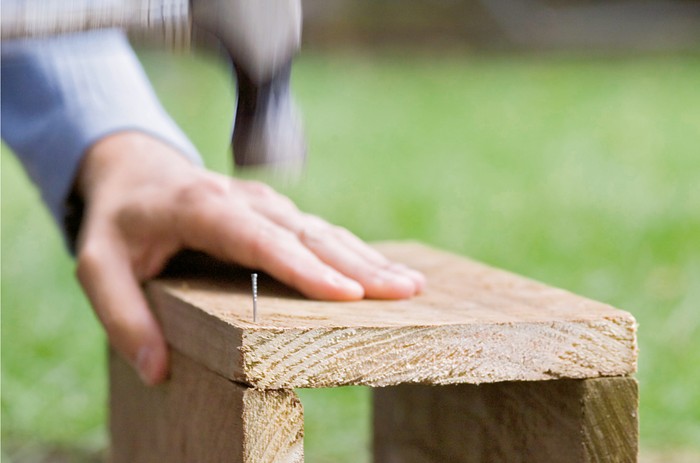 How to make a hedgehog house - nailing the timber pieces together How to make a hedgehog house - nailing the timber pieces together