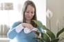 Louise Curley dusting a peace lily